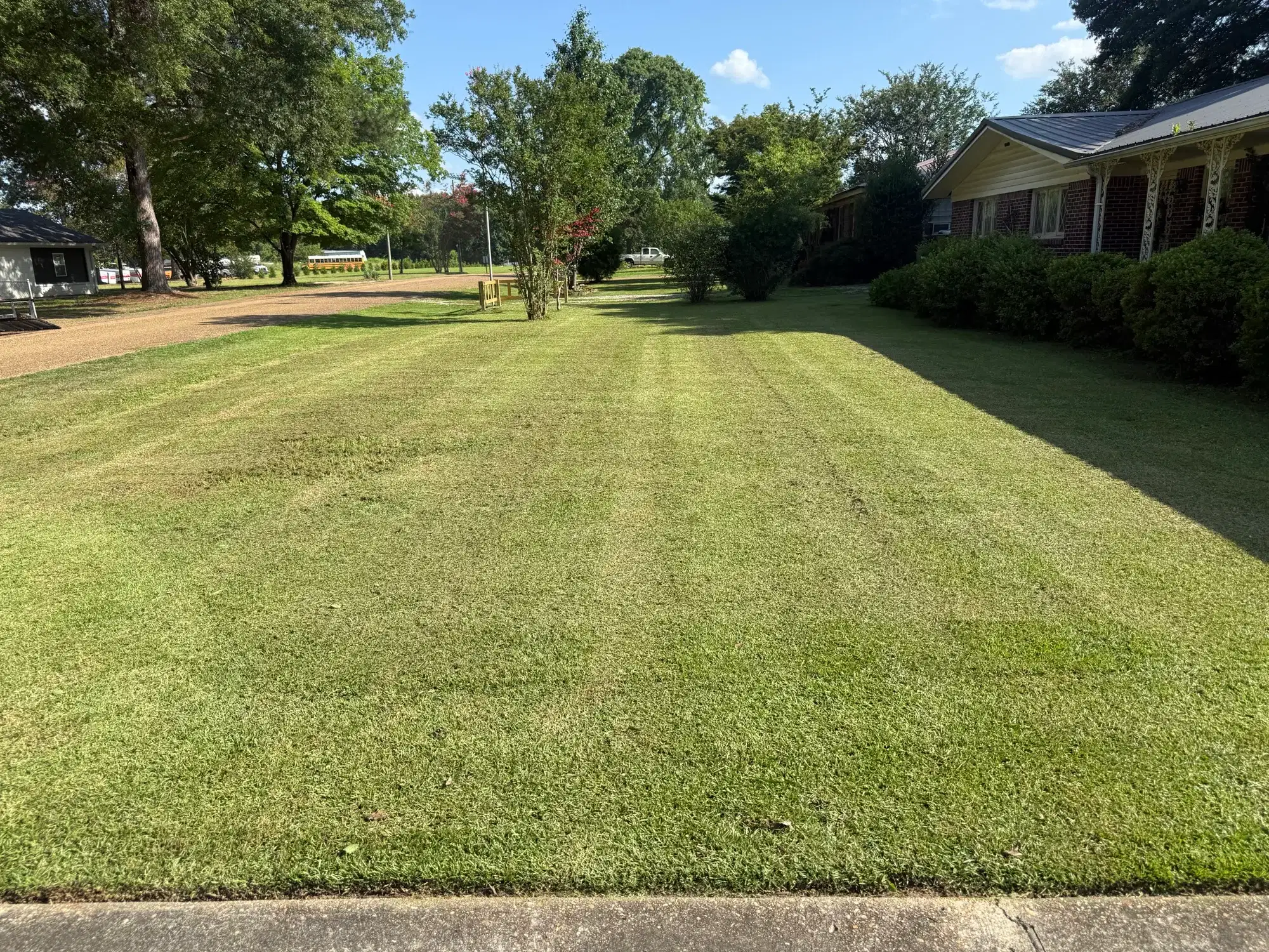 Professionally striped green lawn maintained by Precision Outdoor Services