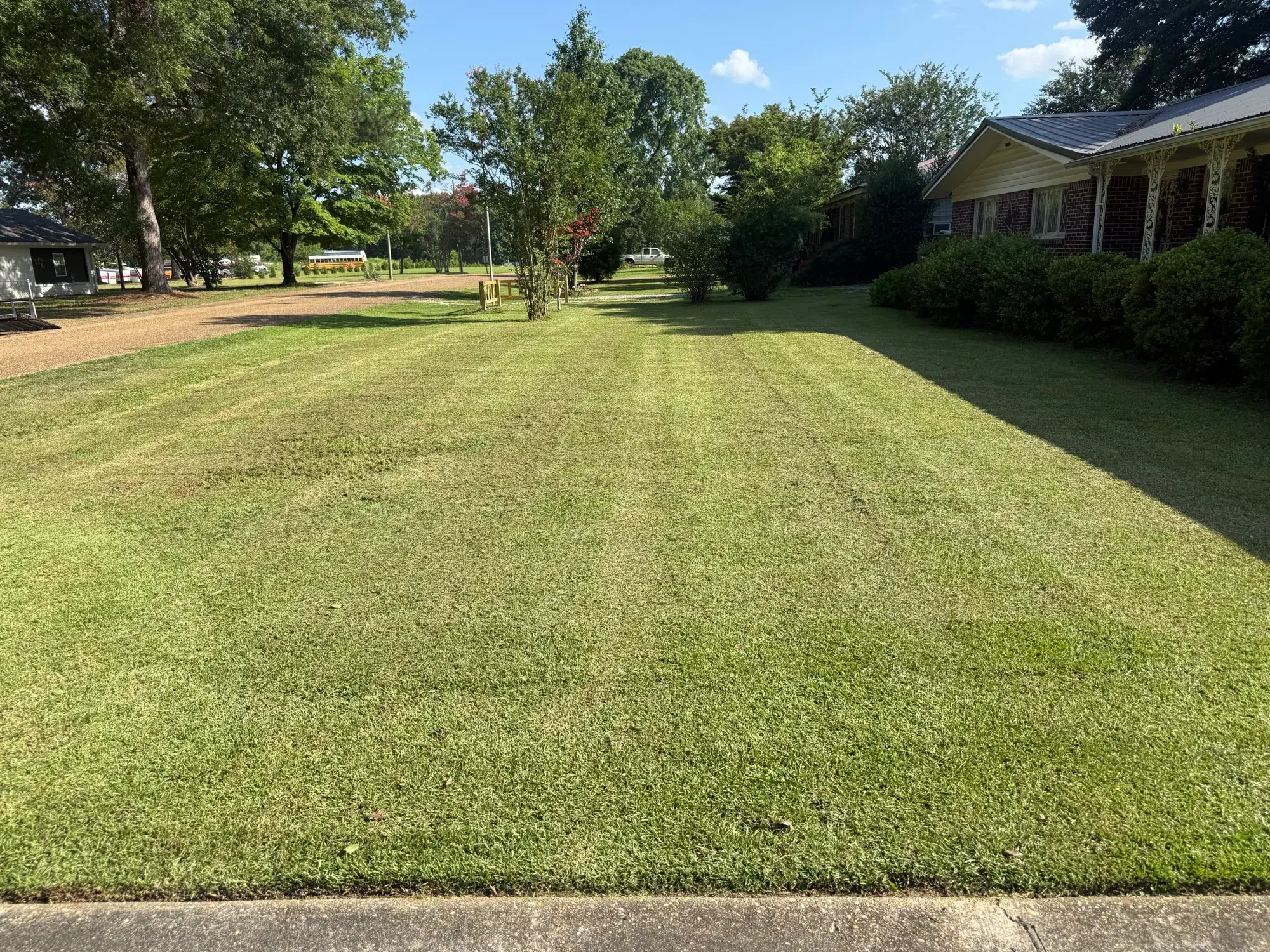 Freshly mowed residential lawn with professional striping by Precision Outdoor Services