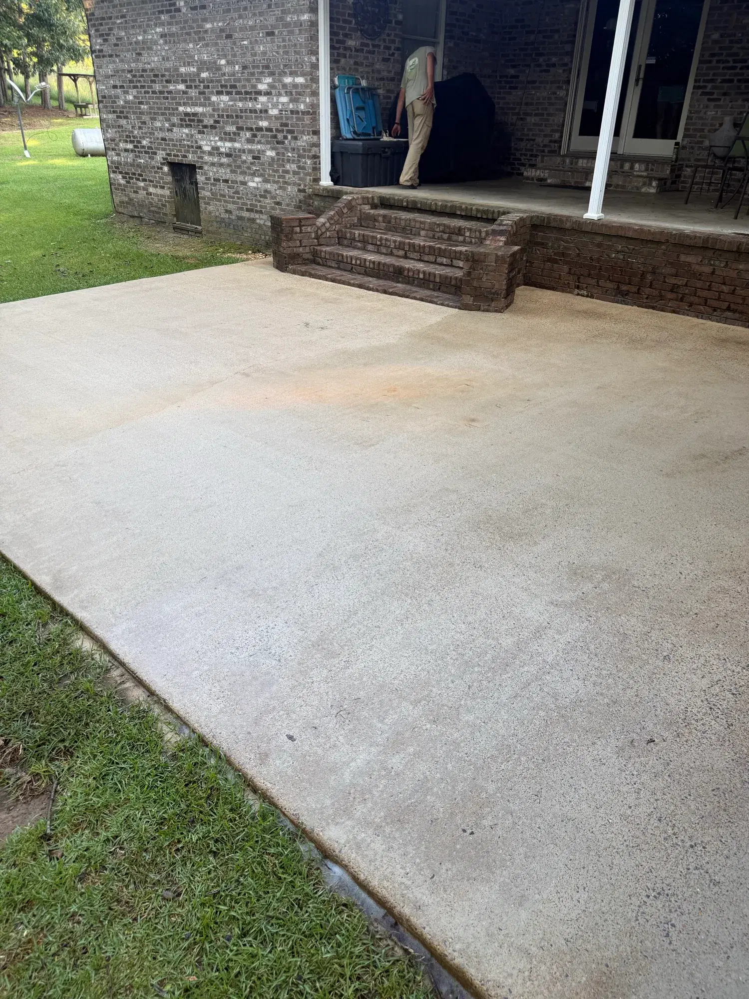 Clean concrete patio after professional pressure washing in West Alabama