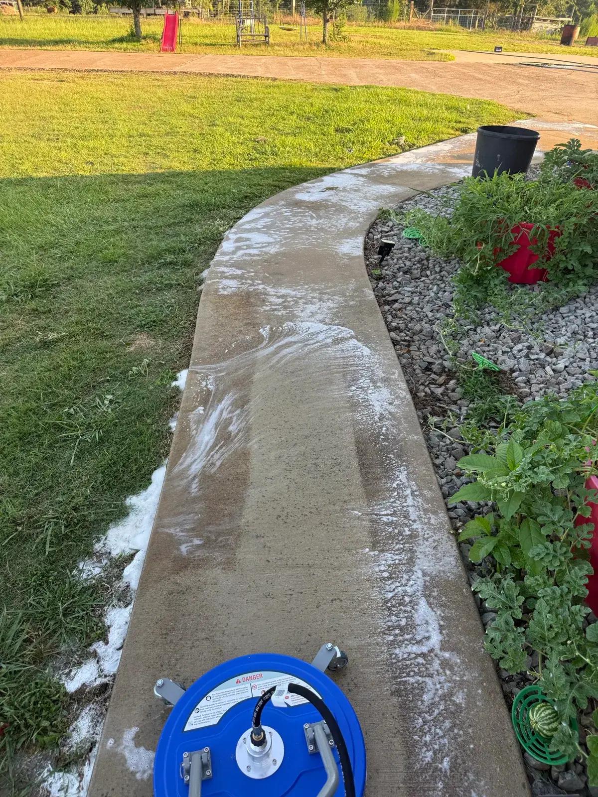 Surface cleaner pressure washing a residential sidewalk
