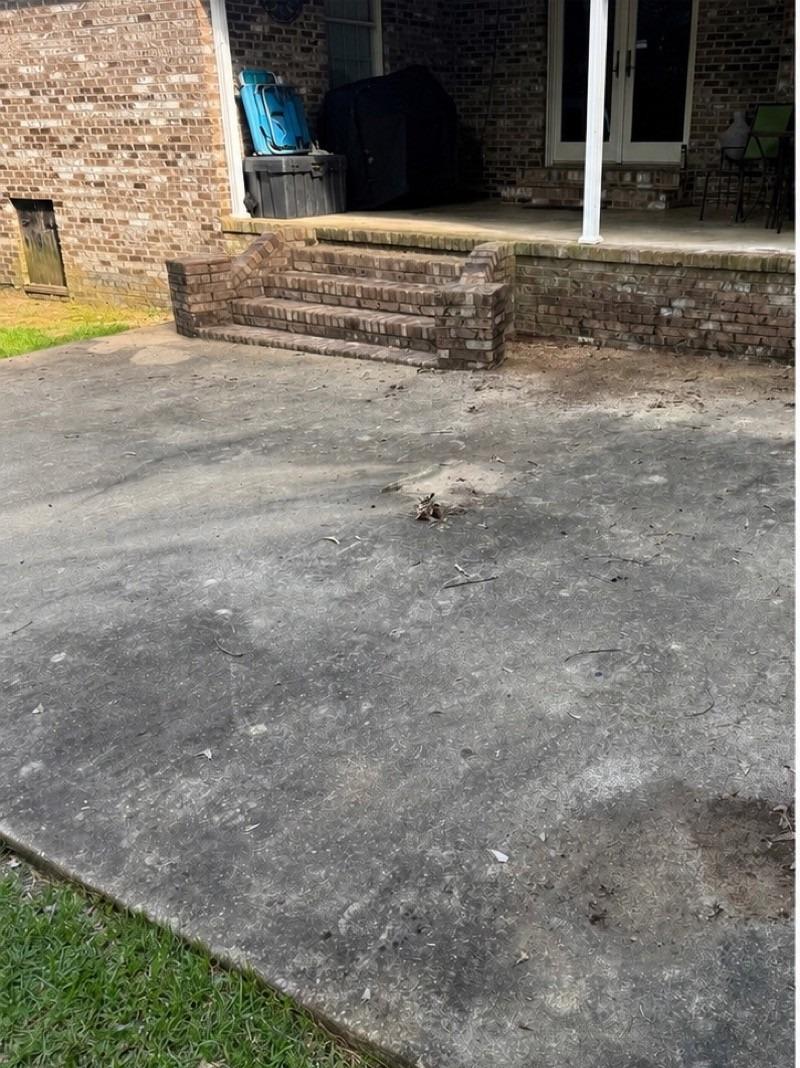 Heavily stained patio before pressure washing