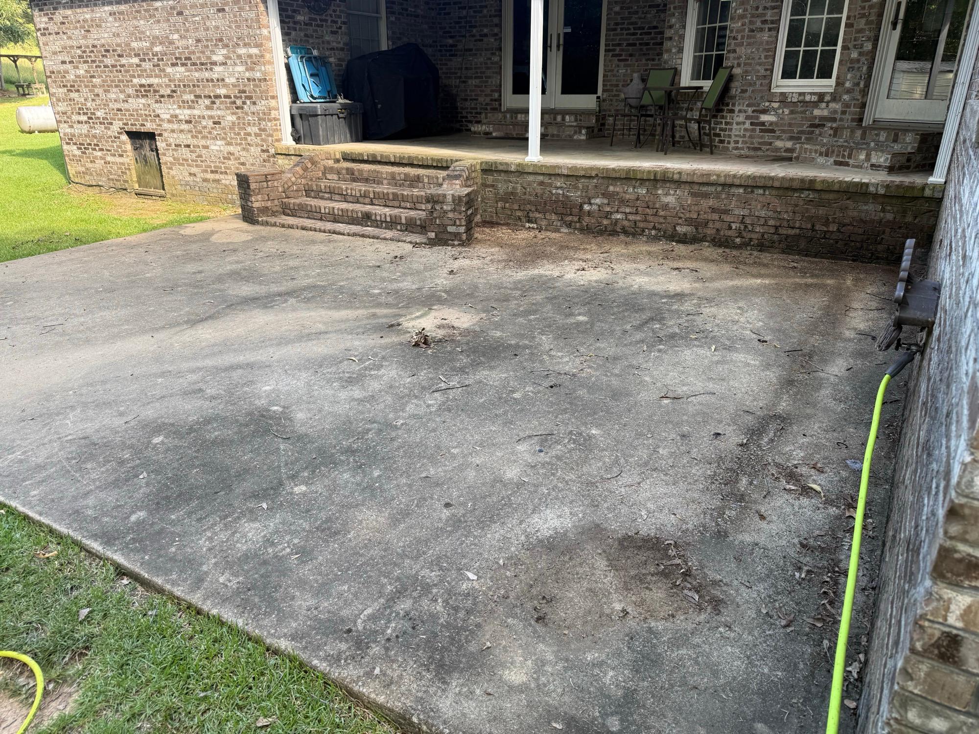 Stained and dirty concrete patio before pressure washing